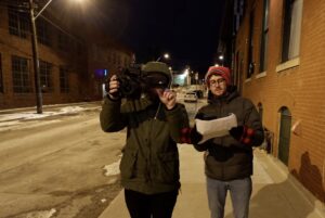 Writer director producer Scott Hipp discusses a scene with a camera man