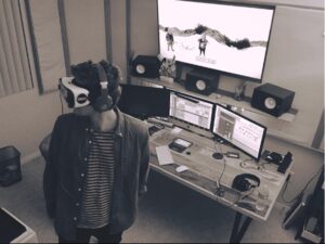 Writer Director Producer Scott Hipp wears virtual reality goggles while editing